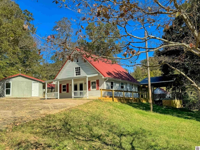 view of front facade with a front lawn and a storage shed