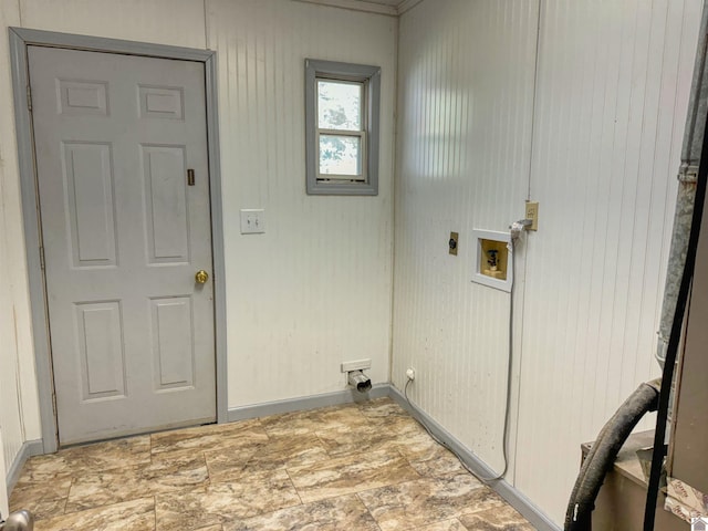 washroom featuring hookup for a washing machine, hookup for an electric dryer, and wooden walls