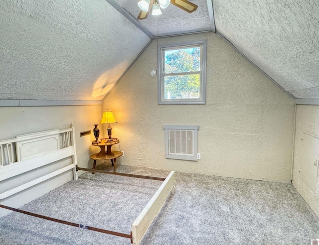 additional living space with ceiling fan, a textured ceiling, lofted ceiling, and carpet floors