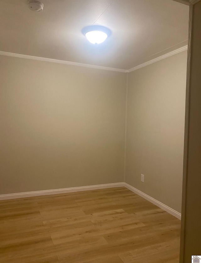 unfurnished room with crown molding and light hardwood / wood-style flooring