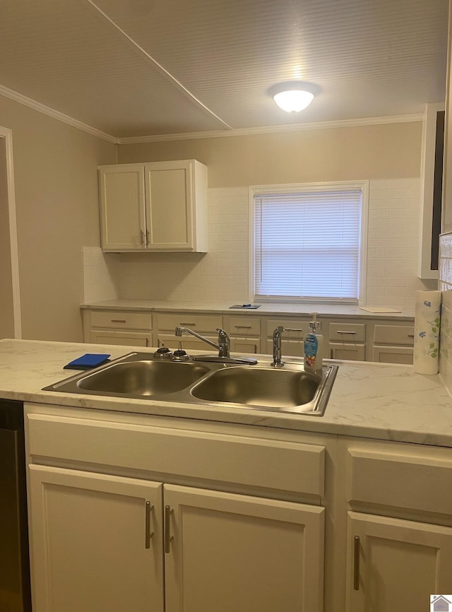 kitchen with crown molding, sink, stainless steel dishwasher, light stone counters, and decorative backsplash