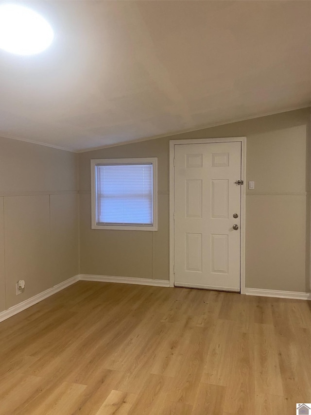 foyer with vaulted ceiling and light wood-type flooring