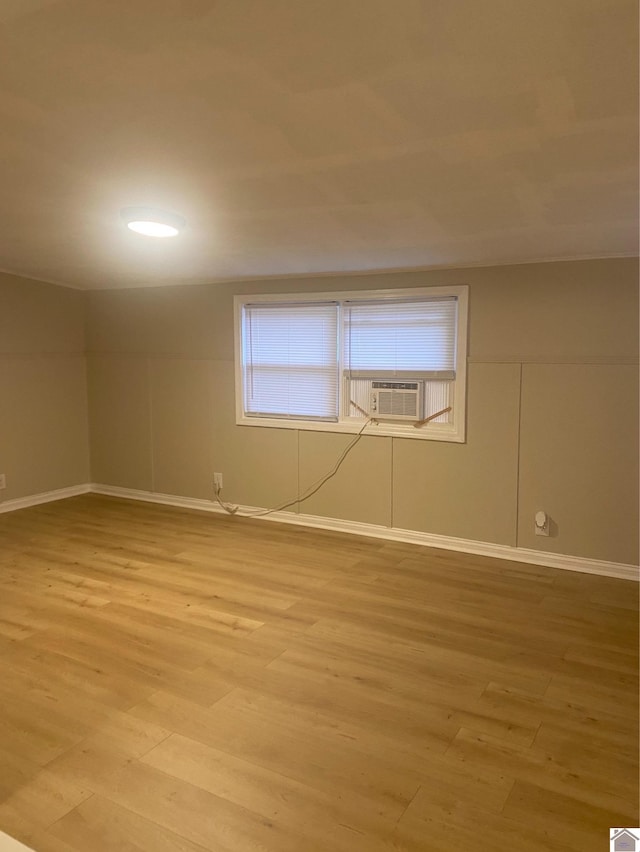 spare room with light hardwood / wood-style flooring and cooling unit