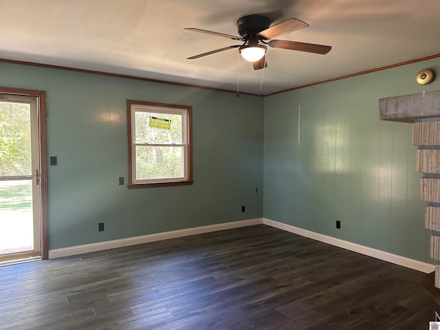 spare room featuring ornamental molding, dark wood-type flooring, a healthy amount of sunlight, and ceiling fan