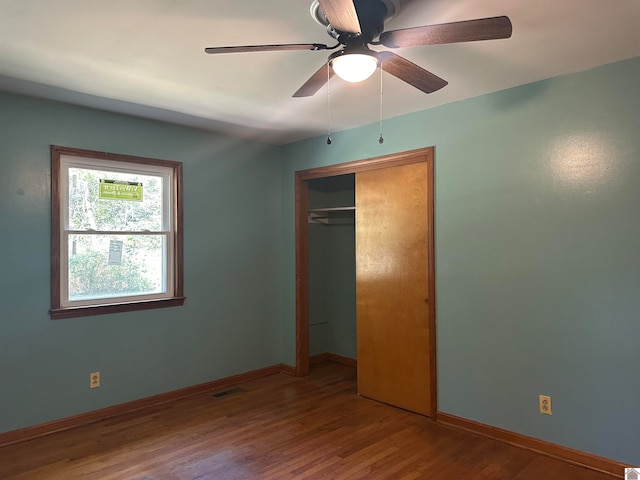 unfurnished bedroom featuring a closet, ceiling fan, and wood-type flooring