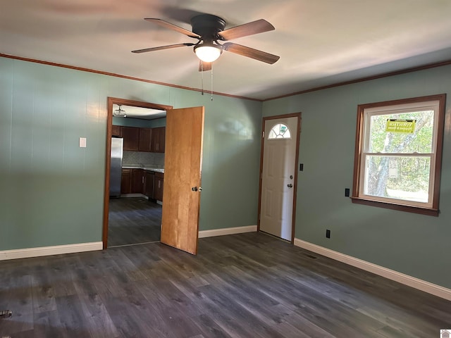 entrance foyer featuring crown molding, ceiling fan, and dark hardwood / wood-style flooring