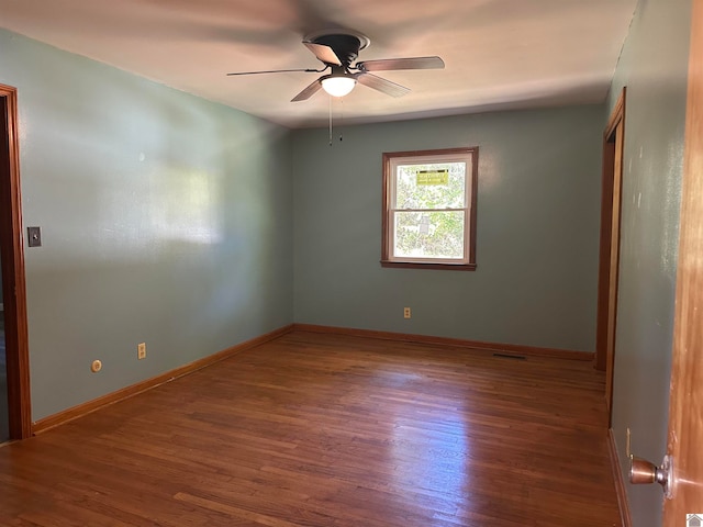 empty room featuring ceiling fan and dark hardwood / wood-style flooring