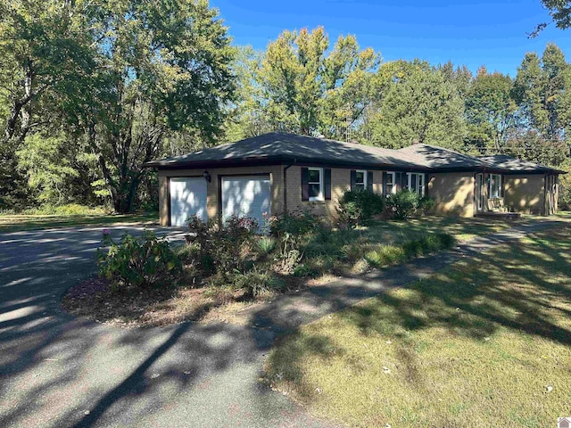 view of front of home with a front yard and a garage