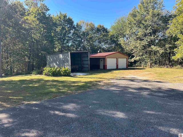 view of outbuilding featuring a yard and a garage