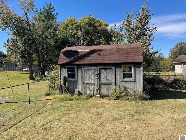 view of outbuilding featuring a lawn