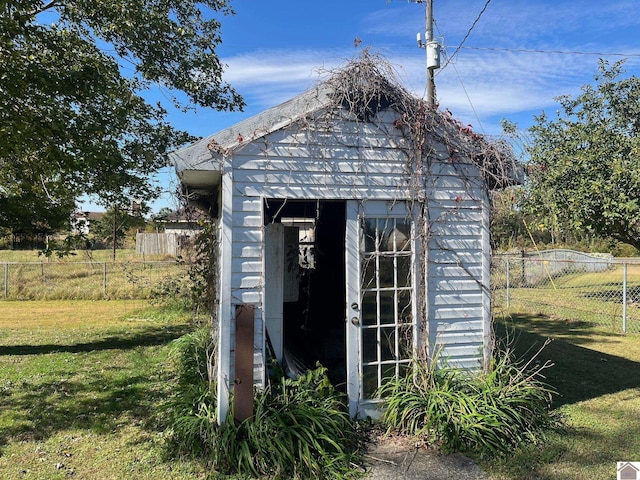 view of outbuilding with a yard