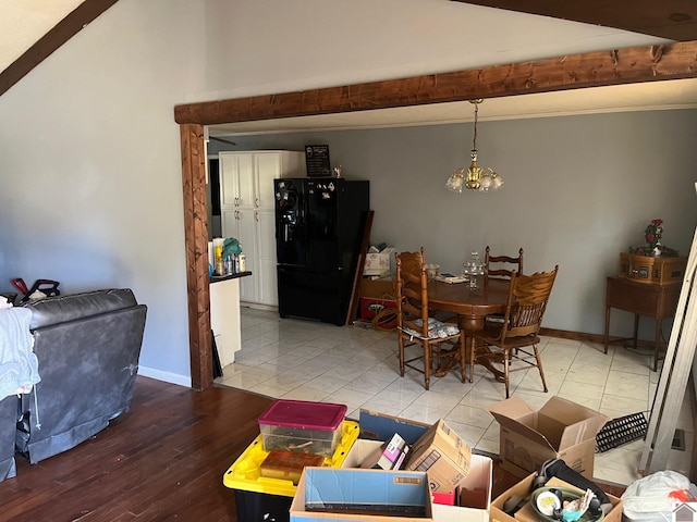 dining area featuring hardwood / wood-style flooring, a notable chandelier, and beamed ceiling