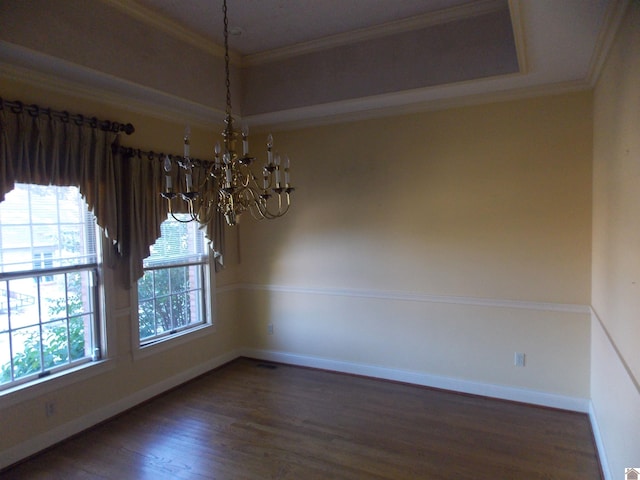 empty room featuring a chandelier, crown molding, and dark hardwood / wood-style flooring