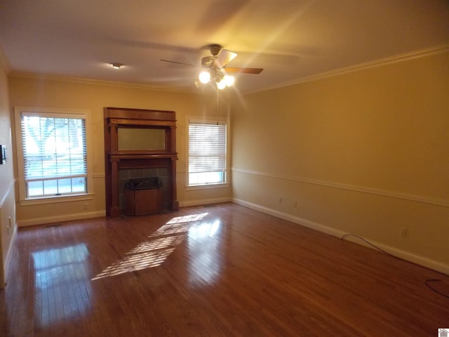 unfurnished living room featuring dark wood-type flooring, crown molding, and plenty of natural light