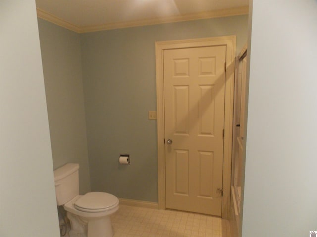 bathroom with ornamental molding and toilet