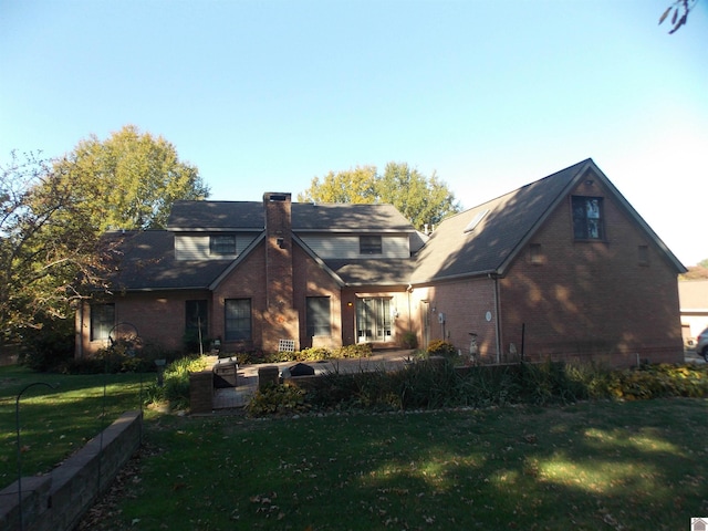 rear view of property featuring a yard