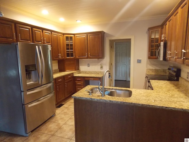 kitchen with kitchen peninsula, sink, crown molding, light tile patterned floors, and appliances with stainless steel finishes