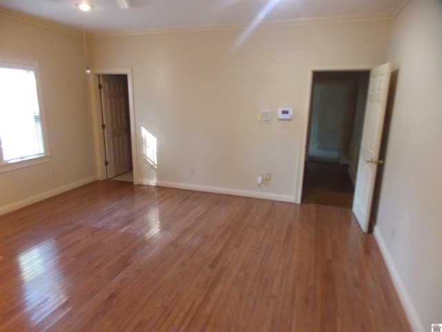 spare room with crown molding and hardwood / wood-style floors