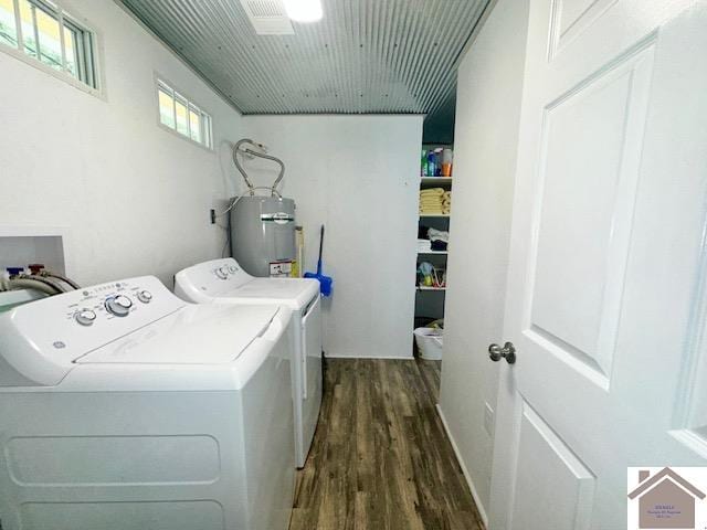 laundry area featuring dark wood-type flooring, washer and clothes dryer, and water heater