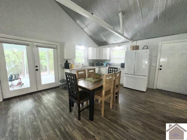 dining room with dark hardwood / wood-style flooring, french doors, and vaulted ceiling