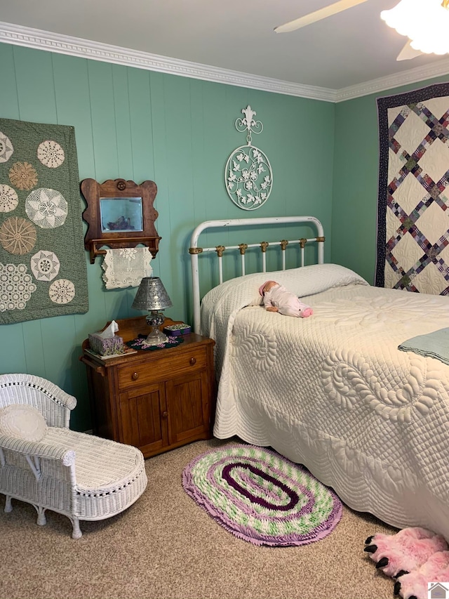 carpeted bedroom with ornamental molding and ceiling fan