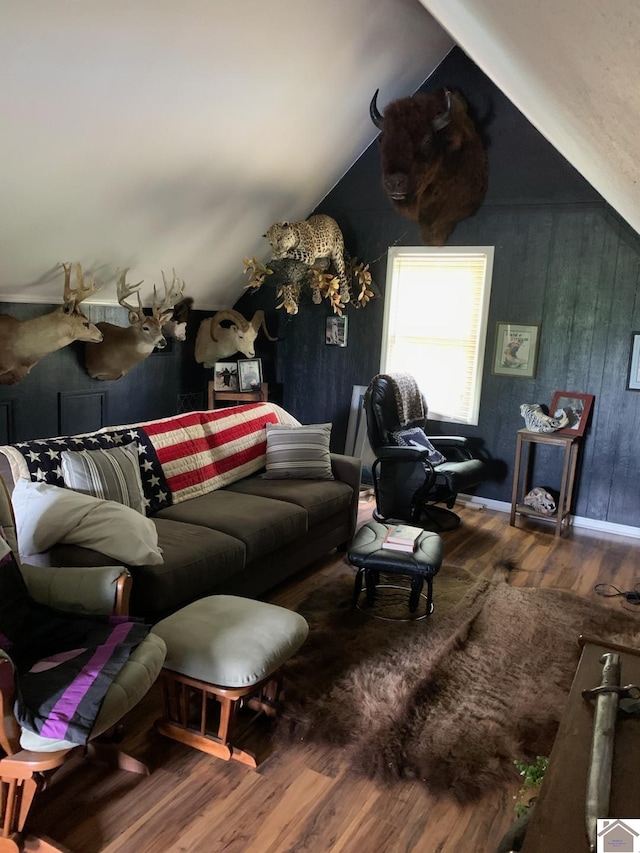 living room featuring hardwood / wood-style flooring and vaulted ceiling