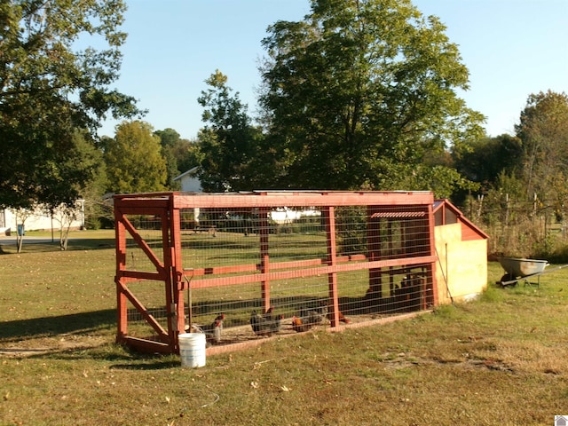 exterior space featuring an outdoor structure and a yard