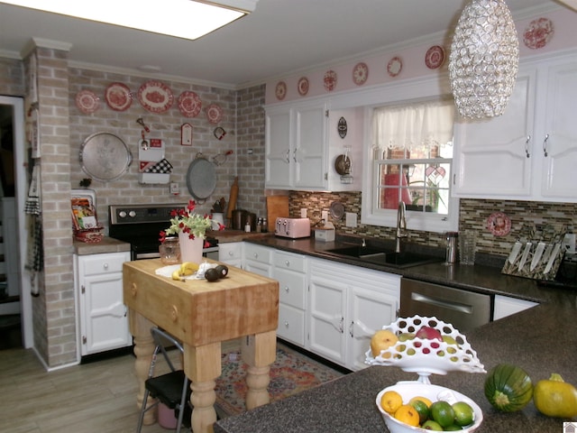 kitchen with white cabinetry, hardwood / wood-style flooring, ornamental molding, dishwasher, and sink