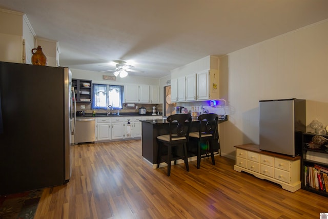 kitchen featuring white cabinetry, ceiling fan, appliances with stainless steel finishes, and dark hardwood / wood-style floors