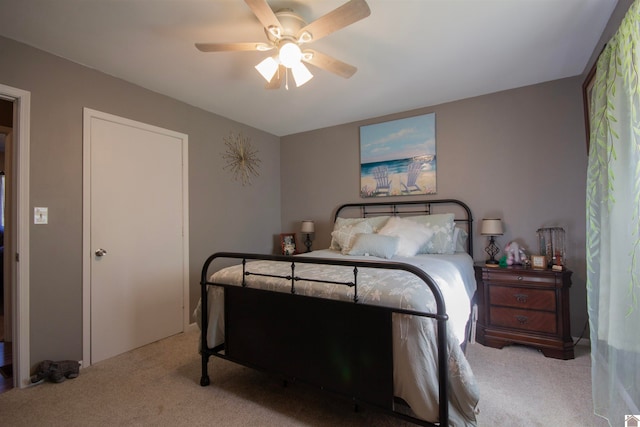 bedroom with light carpet and ceiling fan