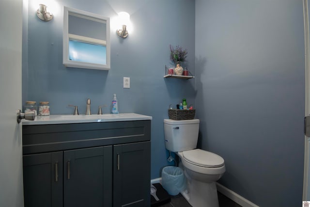 bathroom with vanity, toilet, and tile patterned flooring