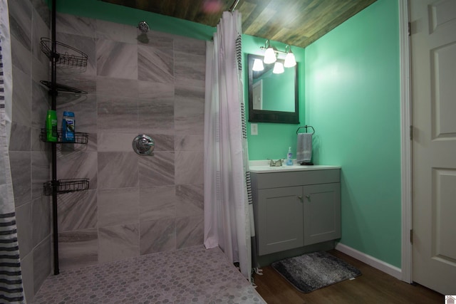 bathroom featuring vanity, curtained shower, and wood-type flooring