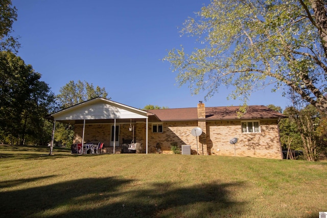 rear view of property featuring a yard