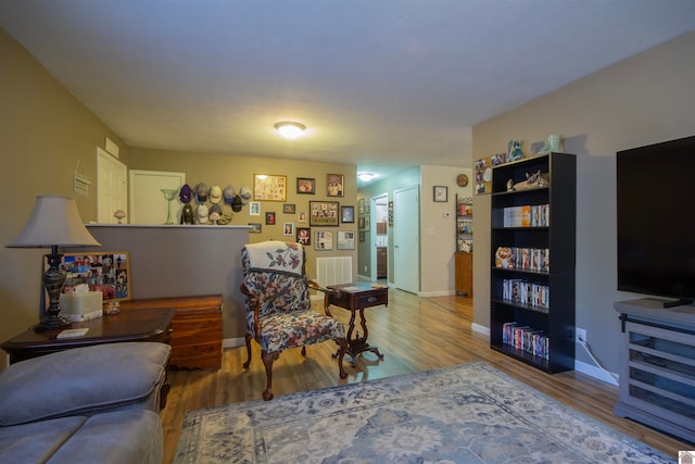 sitting room with wood-type flooring