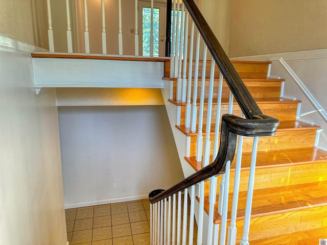 stairs with tile patterned flooring