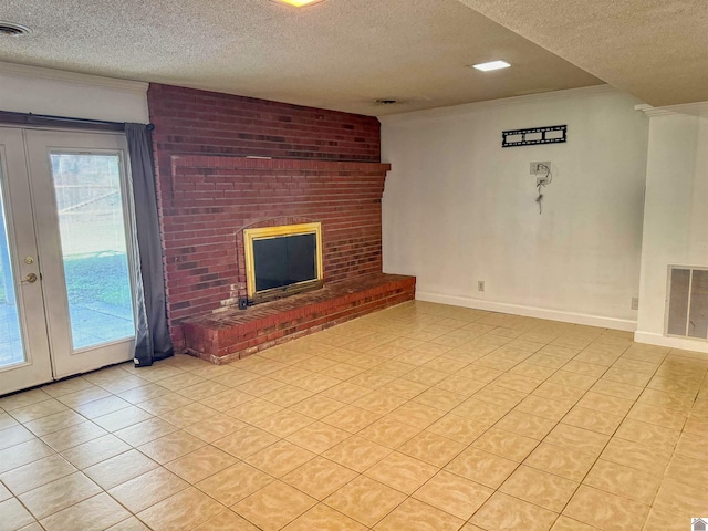 unfurnished living room featuring french doors, a textured ceiling, a fireplace, and crown molding