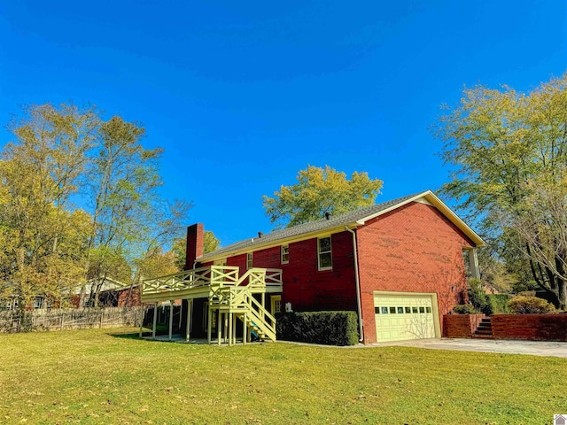 back of property with a lawn and a garage