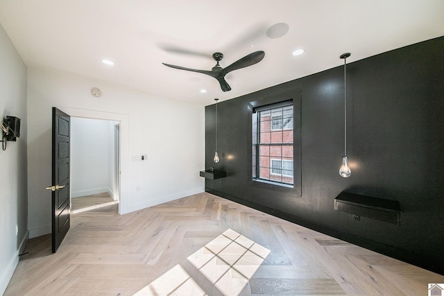 empty room featuring light parquet flooring and ceiling fan