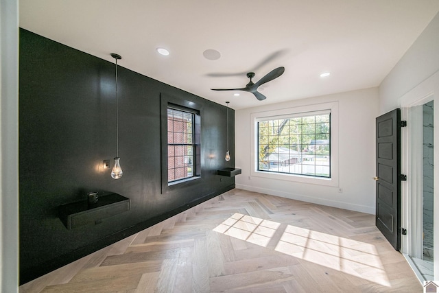 spare room featuring light parquet floors and ceiling fan