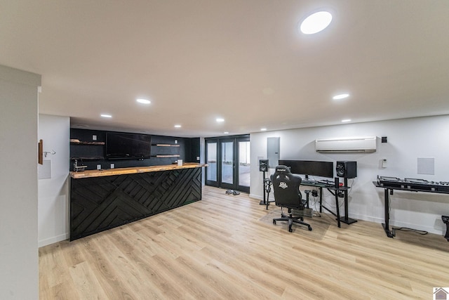 kitchen featuring french doors, a wall mounted AC, and light hardwood / wood-style floors