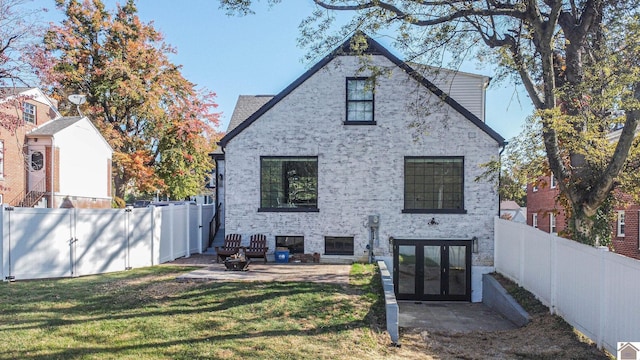 rear view of house featuring a patio and a lawn