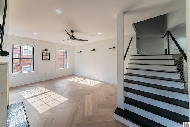 spare room featuring light parquet floors and ceiling fan