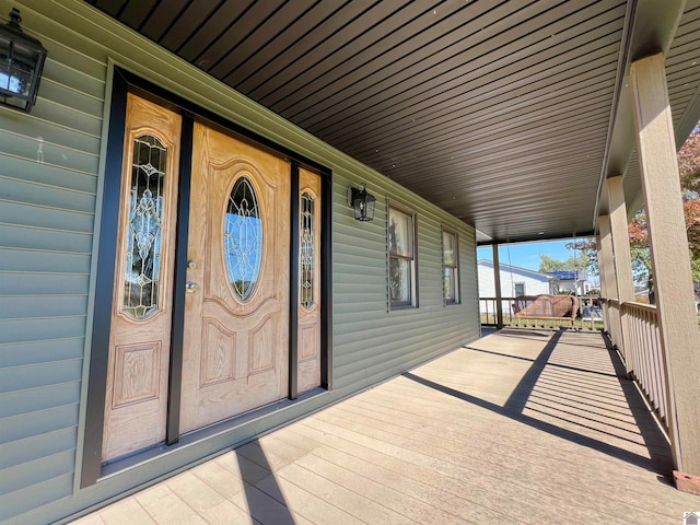 view of exterior entry featuring a porch