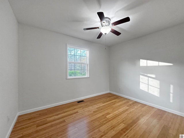 spare room featuring light wood-type flooring and ceiling fan