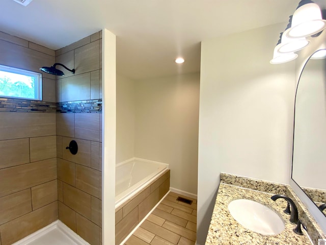 bathroom with vanity and plus walk in shower