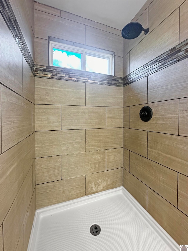 bathroom with tiled shower