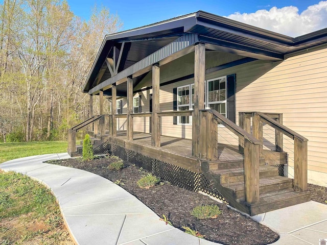 view of exterior entry featuring covered porch