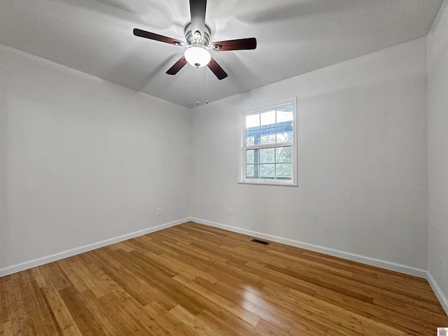 empty room with wood-type flooring and ceiling fan