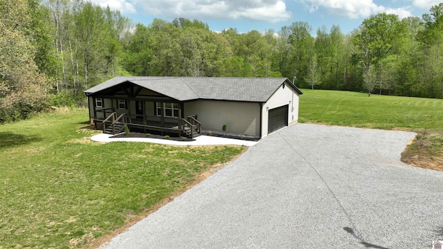 view of front of property featuring a front yard and a garage