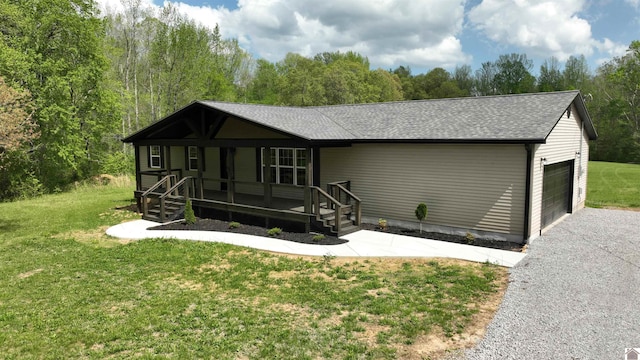 single story home with a front yard, a garage, and a porch